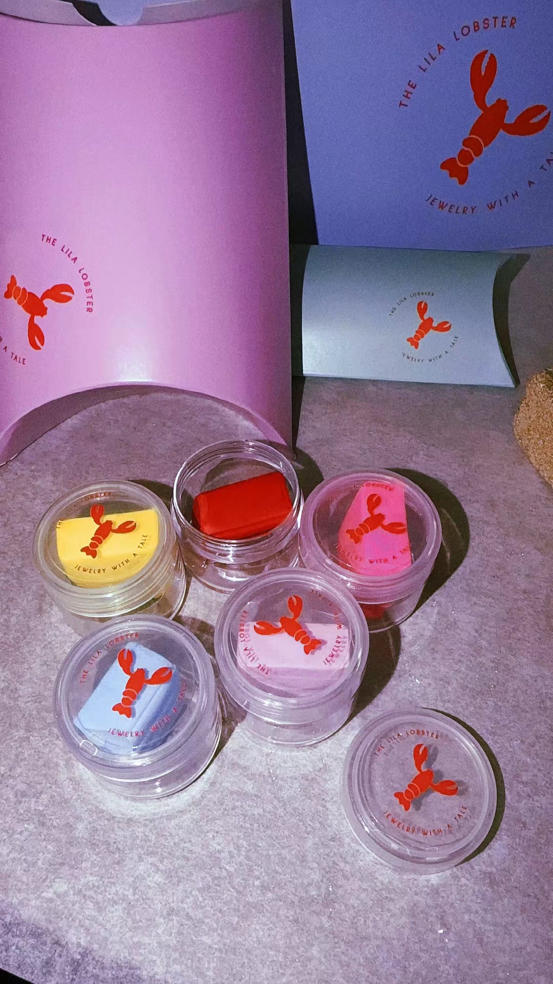 Complete enamel set with TheLilaLobster branded packaging, five colorful glass enamel containers in yellow, red, blue, pink, and coral