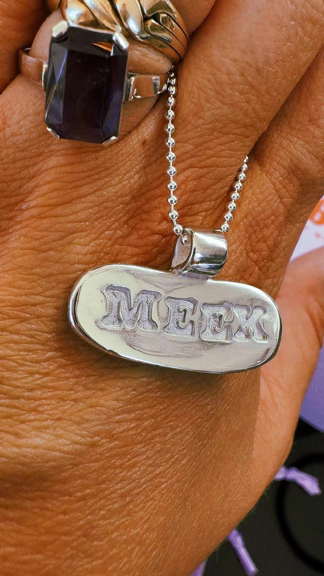 A handmade fine silver name pendant on a ball chain, cleaned and polished