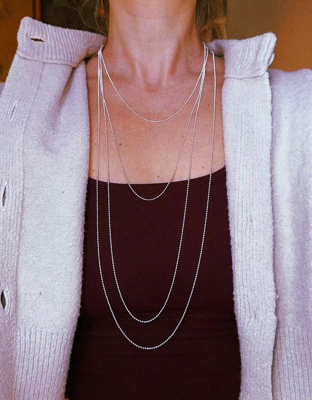 Fine silver chain necklaces layered at several different lengths